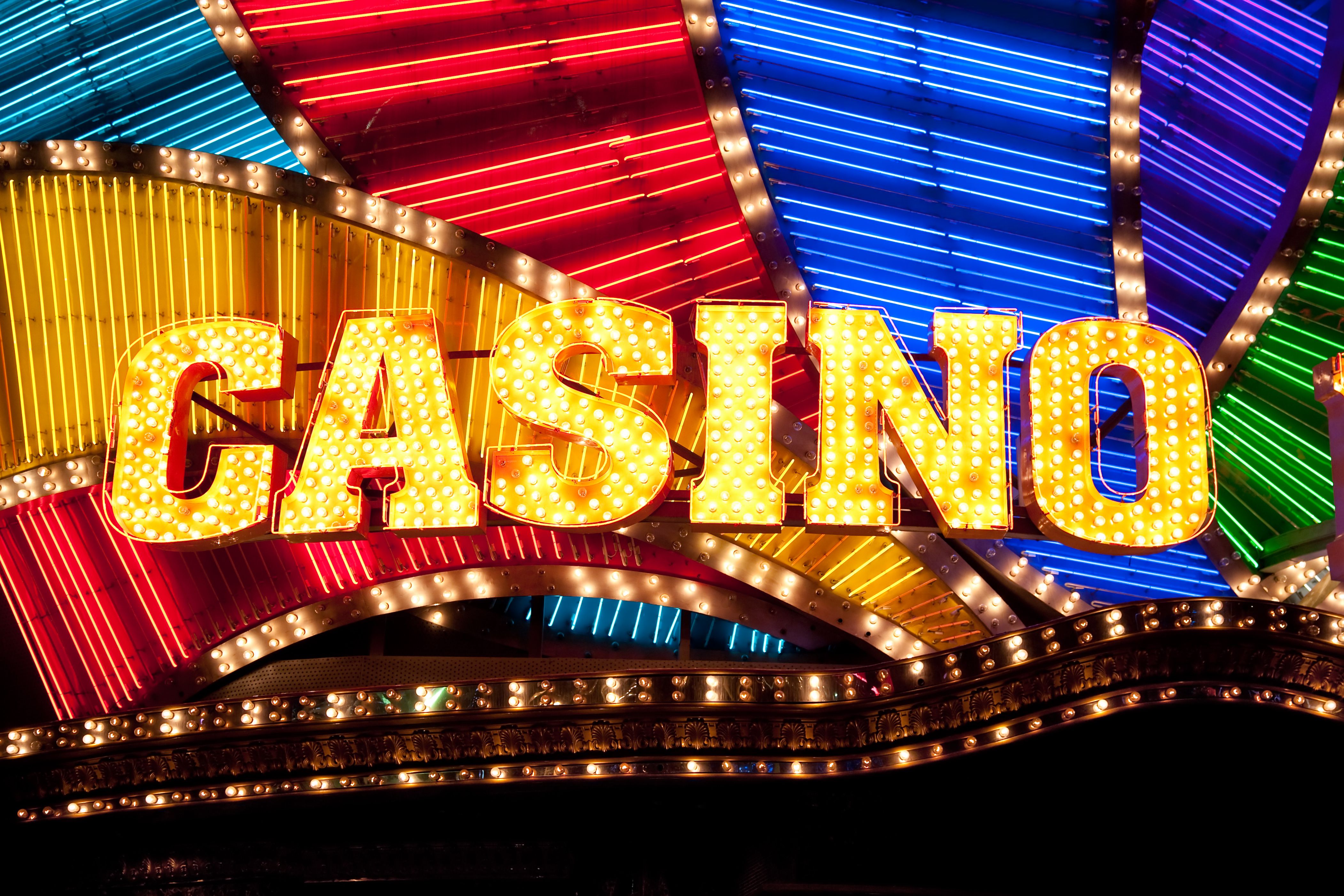 A modern graphic showcasing the Ignition Casino logo with images of poker and slots.